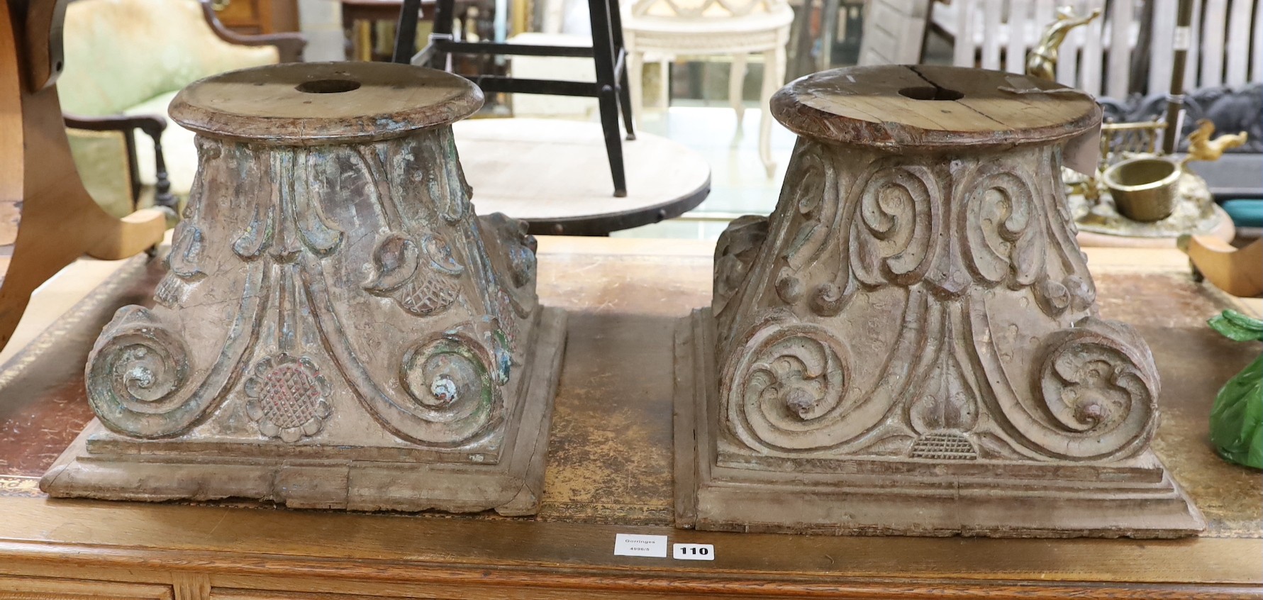 A near pair of carved and painted wood Corinthian column capitals, width 41cm, depth 41cm, height 31cm